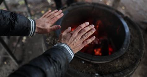 Closeup Of Homeless Hands Warming Themselves By Fire Stock Video