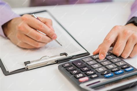 photo close   businessman calculating invoices  calculator