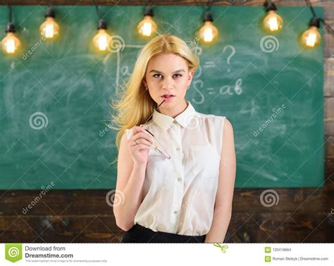 teacher concept woman with long hair in white blouse stands in