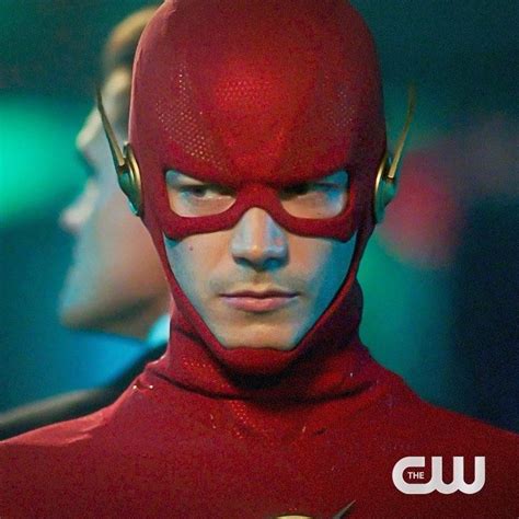 The Flash Standing In Front Of Another Man With His Head Turned To Look