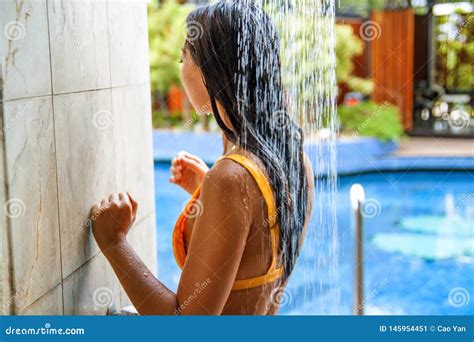 Beautiful Woman Taking A Shower Near The Swimming Pool In Hotel Stock