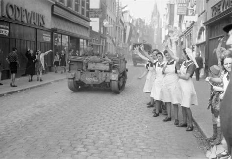 dutch nurses wave  passing british vehicles   liberation  eindhoven  september