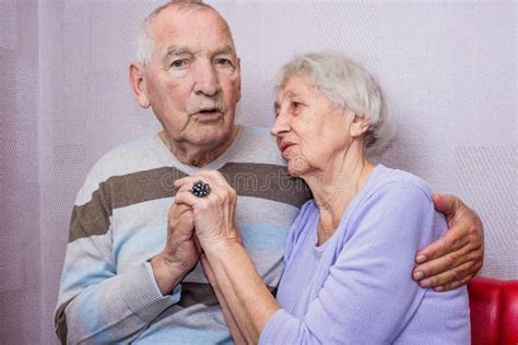 Happy Affectionate Mature Old Man And Woman Embracing Looking At Camera