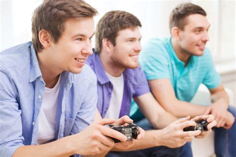 smiling friends playing video games  home stock photo image