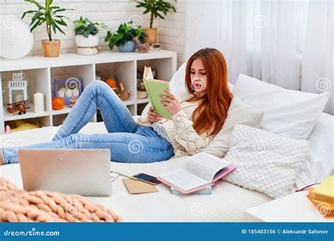 cute student girl  homework lying   bed  home distance learning stock photo image