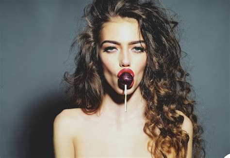 premium photo sexy woman with lollipop in sensual mouth