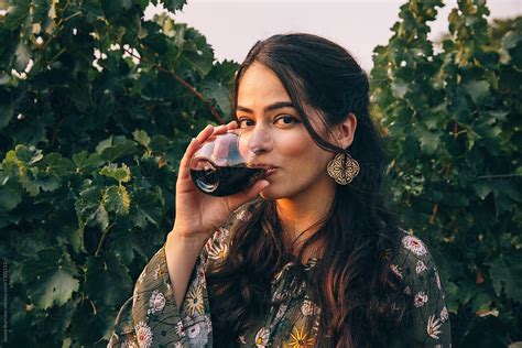 pretty latina woman drinking wine by jayme burrows
