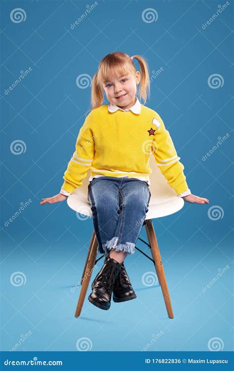 cute  girl sitting  chair  smiling  camera stock photo