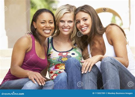 Three Girlfriends Lying On The Bed With Smartphone Royalty Free Stock