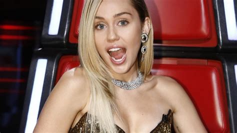 miley cyrus goes glam on the voice catches blake shelton in a sexy