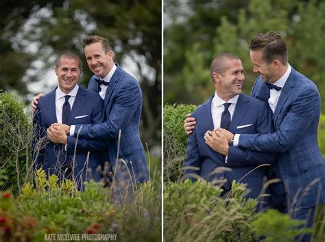 Two Sweet Grooms Holding Hands At Their Monument