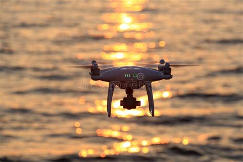 remote controlled drone flying sparkle sunlight  sea editorial photo image  outdoor