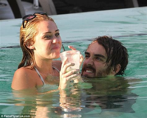 miley cyrus gets very close to male friend cheyne thomas as they frolic in the pool daily mail