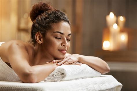 beautiful african woman smiling resting relaxing in spa salon free photo