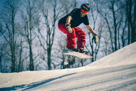 man riding  snowboard  mid air jump  stock photo