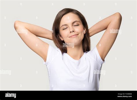 peaceful woman putting hands  head isolated  grey background stock photo alamy
