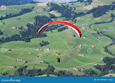 paraglider flying   field  teh alps stock photo image  field adrenaline