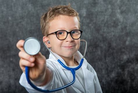cute kid boy wear medical uniform playing doctor portrait stock photo image  play medic