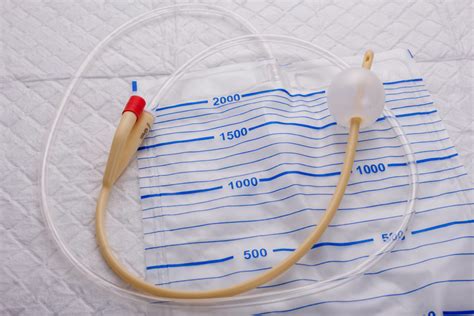 Nurse Inflates Urinary Catheter Bulb With Leg Drainage Bag On Sterile