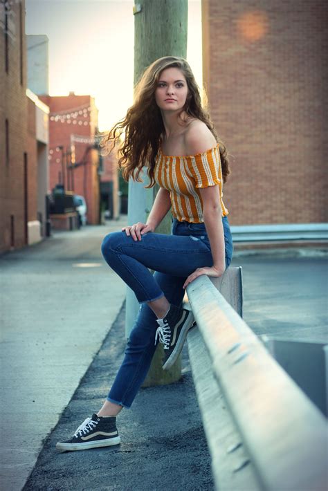 senior picture model pose street style downtown guardrail sunset