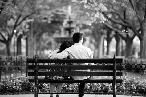 A Man And Woman Sitting On A Park Bench