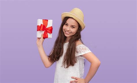 Cheerful Teen Girl Showing Wrapped Present Stock Image