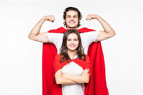 young pretty couple  red hero  showing arm muscle isolated  white background stock photo