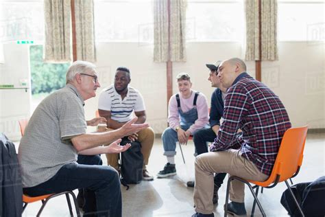 men talking  listening  group therapy stock photo dissolve