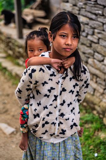 Nepali Girl Carrying Her Sister Village Near Annapurna Range Stock