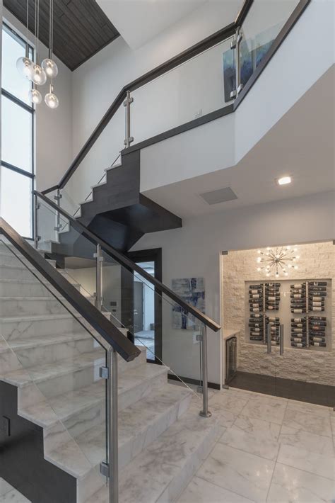 Glass Panel Staircase With Espresso Stained Wood Railings And Chrome