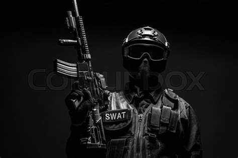 spec ops police officer swat in black uniform and face