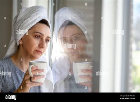 Moody Photo Of A Middle Aged Woman With Towel Turban On Her Head During