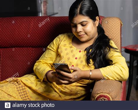 Selective Focus Of An Indian Asian Pretty Woman Using Smart Phone