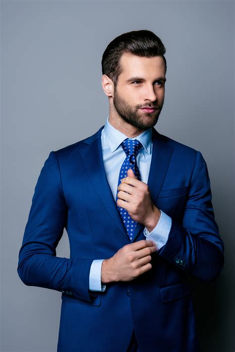 Portrait Of Serious Fashionable Handsome Man Posing In Blue Suit