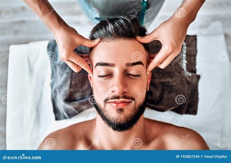 handsome man  head massage  spa salon stock photo image