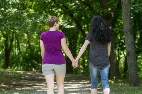 same sex female couple holding hands the law office of laurieanne delitta pllc