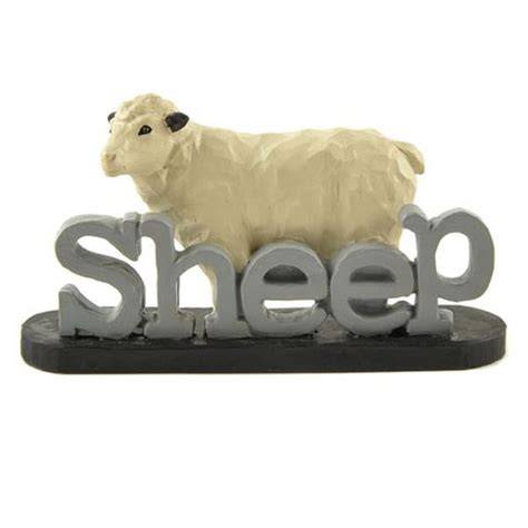 adorable resin sheep stands atop  word sheep  blue gray