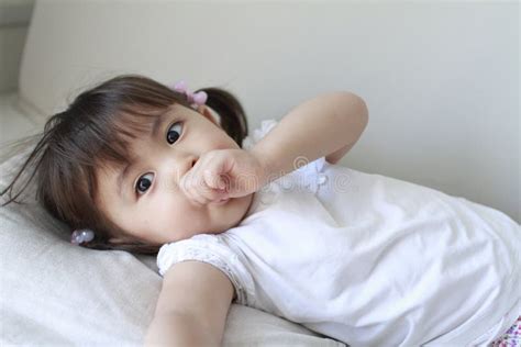 Lying Japanese Girl With Sucking Her Finger Stock Image Image Of