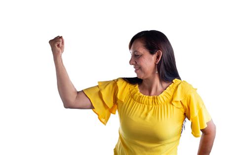 Empowered And Strong Mature Latina Woman Flexing Bicep With Confidence