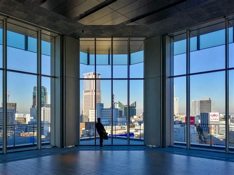 photo person  clear glass room architecture blue sky buildings