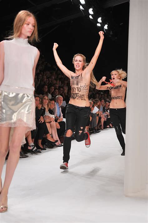 paris fashion week spring 2014 runway model punches topless protesters hollywood reporter
