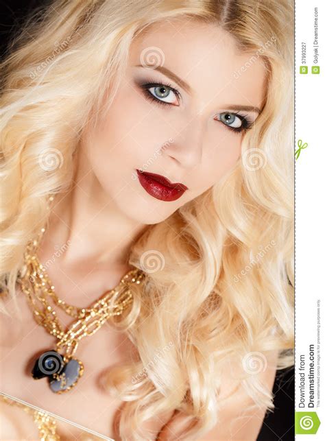 Portrait Of An Attractive Blond Woman With Long Curly Hair