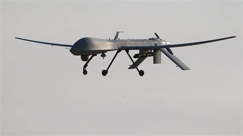 air force mq  predator unmanned aerial vehicle carrying  hellfire missile lands