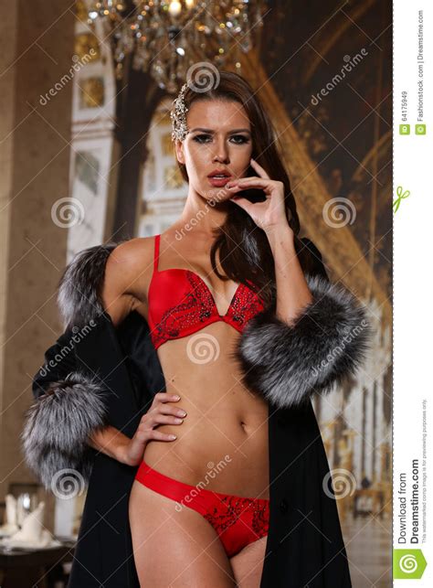 Beautiful Brunette Woman In Red Lingerie And Luxury Fur Coat In Fashion