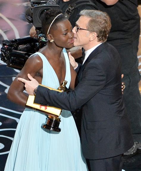 christoph waltz embraced lupita nyong o after presenting her with the best kisses at 2014