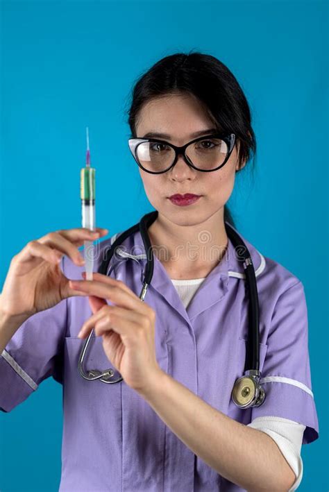 Woman Doctor Or Nurse In White Med Uniform And Gloves With Syringe In