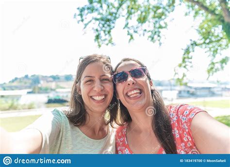 Girlfriends Taking Selfie Together Having Fun Outdoors