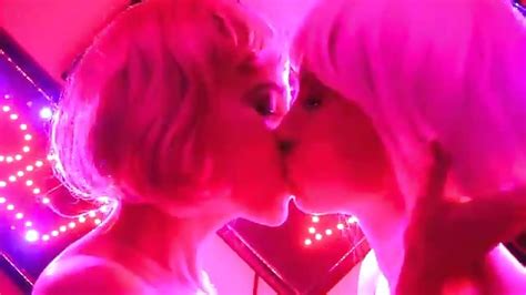 Lesbians Kiss In A Pink Toned Room