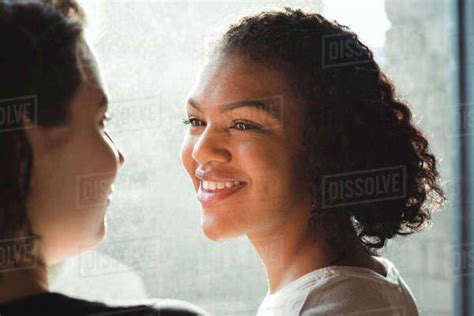Close Up Of Lesbian Couple Smiling While Having A Conversation Stock