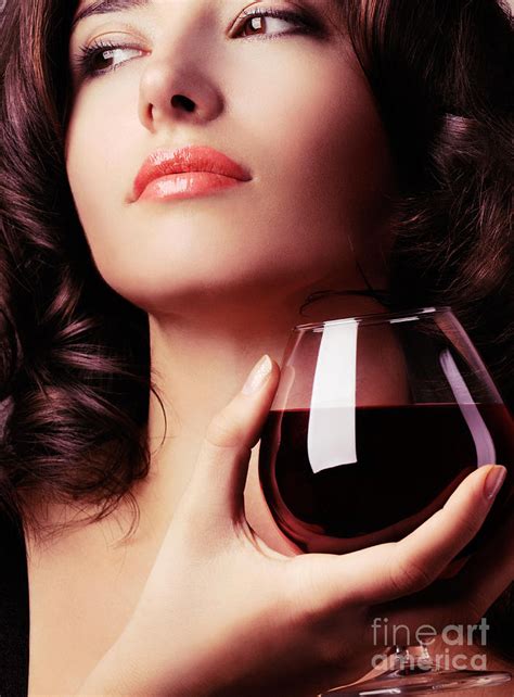 portrait of a beautiful woman with glass of wine
